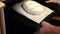 A woman puts in the oven a baking tray with a lump of dough from whole-grain flour. Baking bread at home.