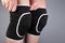 Woman puts protective sports knee pads