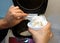 A woman puts rice in a bowl