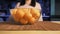 A woman puts ripe juicy tangerines in a transparent glass plate.