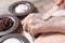 A woman puts a spatula of coffee homemade scrub on her hand. SPA, beauty. Ingredients for making scrub, coffee beans, sugar, cream