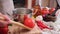 woman puts tomato to pot with hot boiling water for blanching