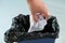 Woman puts wrinkled paper in a recycling bin, close-up hands, concept of household waste disposal, different types of garbage into