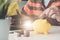 A woman putting coin in yellow piggy bank while using laptop for calculator money saving - Financial Saving Concept