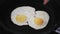 Woman putting Cooked two eggs on plate