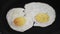 Woman putting Cooked two eggs on plate