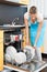 Woman putting dishes in the dishwasher