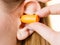 Woman putting earplugs