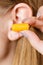 Woman putting earplugs