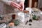 Woman putting expanded clay into White ceramic Pot for Succulent haworthia planting