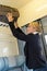 Woman putting her baggage on train grid