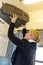 Woman putting her luggage on train grid