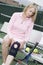 Woman Putting On A Knee Brace To Play Tennis