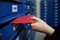 Woman putting letter into mailbox, closeup