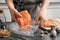 Woman putting marinated salmon fillet into plastic bag