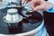 Woman putting needle on vinyl record on turntable