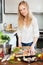 Woman putting pieces of saltwater fish into frying pan