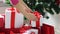 Woman putting present under christmas tree