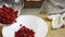 Woman putting raspberries in plate