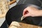 Woman putting raw gyoza on frying pan with hot oil, closeup