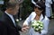 Woman putting ring on groom