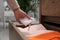 Woman putting scented sachet into drawer with clothes, closeup