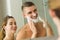 Woman putting shaving foam on boyfriends face