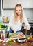 Woman putting sliced fish into frying pan