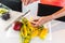 Woman putting the sliced juicy mangos on the wooden stick