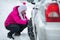 Woman putting snow chains