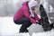 Woman putting snow chains