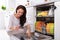 Woman Putting Soap Tablet In Dishwasher Box