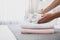 Woman putting soft clean towels on bed indoors, closeup. Space for text