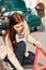 Woman putting triangle sign for car breakdown