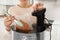 Woman putting vacuum packed meat into pot and using thermal immersion circulator, closeup. Sous vide cooking