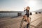 Woman quenches thirst while riding a bike