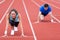 Woman racing with a man at the stadium