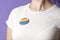 Woman with a rainbow flag badge, symbol of support for the LGBT community