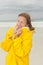 Woman raincoat autumn storm at beach