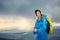 Woman with raincoat hiking in rainy weather