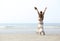 Woman with raised arms at the beach