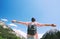 Woman with raised arms up on nature in Dolomites, South Tyrol, I