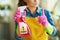 Woman with raised finger and toxic cleaning supplies