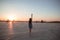 Woman with raised hand standing on the airfield.