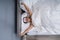 Woman Raising Arm In Bedroom