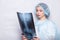 Woman raising her hand up and holding an x-ray picture doctor