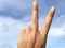 Woman raising two fingers up on hand it is shows peace strength fight or victory symbol, peace sign, number two or letter V in sig