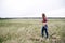 Woman rake dry grass on farm field