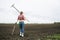 Woman with rake and shovel move away