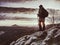 Woman reached mount peak. Girl wears backpack and sunglasses